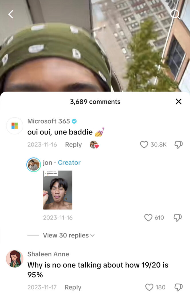 Screenshot of a comment from Microsoft 365 that says "oui oui, une baddie" on a user's TikTok video.